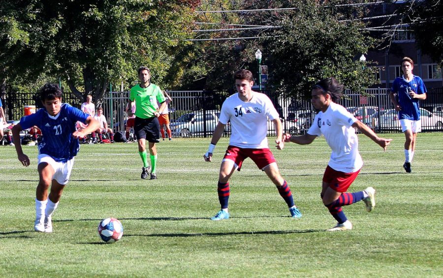 Number 27, Jared Cornejo, a sophomore midfielder, dribbles the ball while two Southern Indiana players apply pressure, guarding him during the home soccer game at Lakeside Field Saturday afternoon. The Panthers lost 3-2 against Southern Indiana.