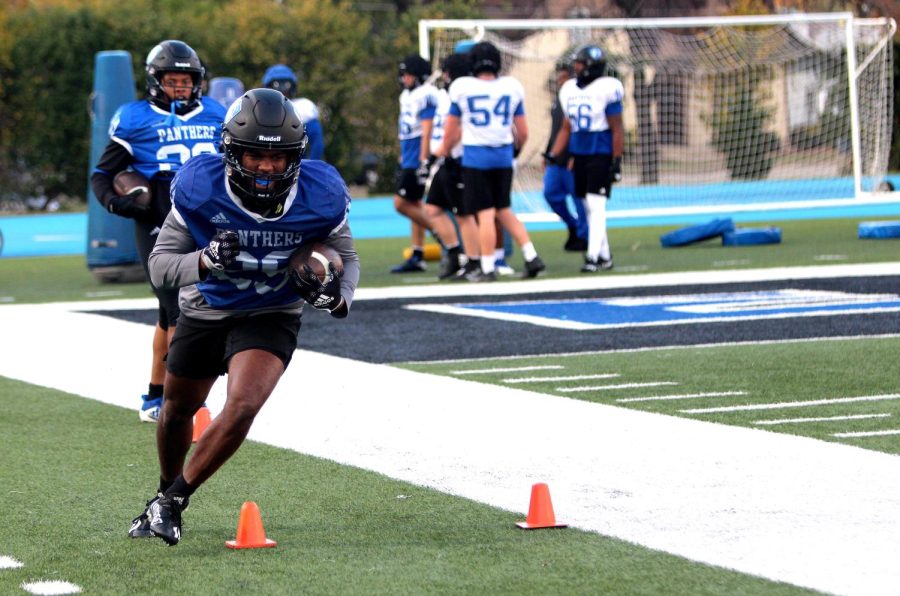 Number 29, Kendi Young, a sophomore runningback, runs with the ball during drills at football practice at OBrien Field Wednesday afternoon.