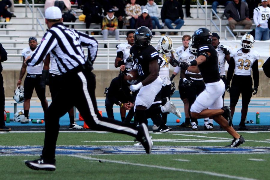 Alexander Oyawale (11), a junior linebacker, runs into the end zone after recovering a fumble, returning it for a 40-yard touchdown during the in the fourth quarter of the homecoming football game against the Lindenwood Lions at OBrien Field Saturday afternoon. Oyawale had five tackles during the game, four of which were solo. The Panthers lost 37-34 to the Lindenwood Lions in a double overtime.