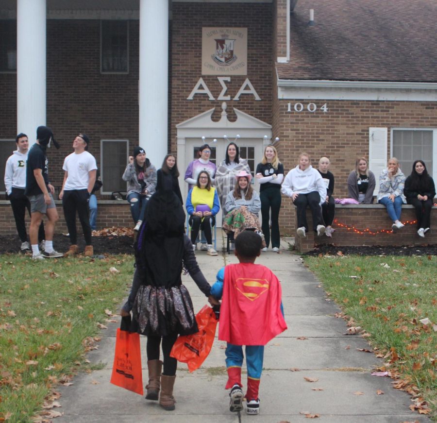 Alpha Sigma Alpha sorority members wait to hand out candy to tricker-treaters on Halloween, Monday night at Greek Court.