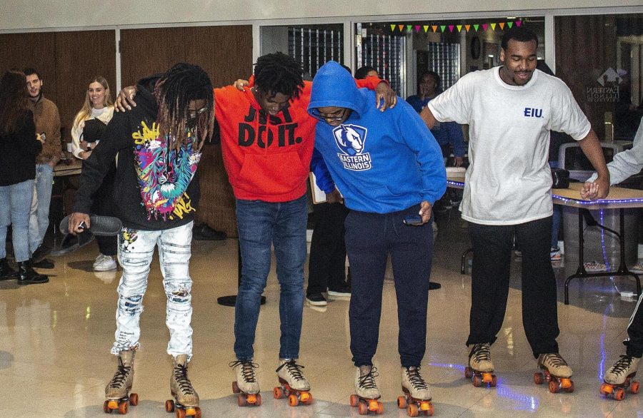 From left, Stanley Alston, a freshman biological sciences major, Jubril Ayoola, a freshman computer informations and technology major, and Elijah Barnes, a freshman business major, skate at the Homecoming Skating Party at the University Ballroom in the Union Thursday evening.