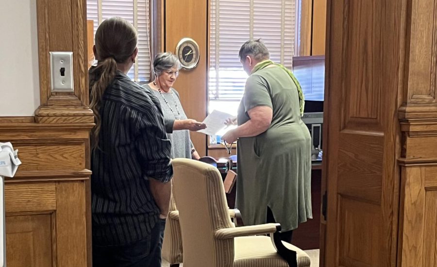 EIU-UPI President Jennifer Stringfellow hands grievance form to Judith Garrell, the secretary for University President David Glassmans office. Glassman was unavailable at the time the grievance were delivered. 