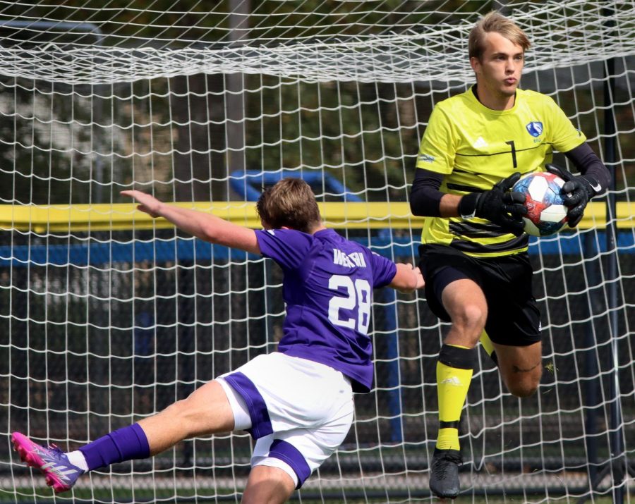 Number 1, Chad Smith (right), a sophomore goalkeeper, catches the ball mid-air after a close shot by number 28 Marco Presta (left), a freshman defender, during the mens soccer game at Lakeside Field Saturday morning. Smith had 6 saves and allowed 1 goal. The Panthers tied 1-1 against the Leathernecks.