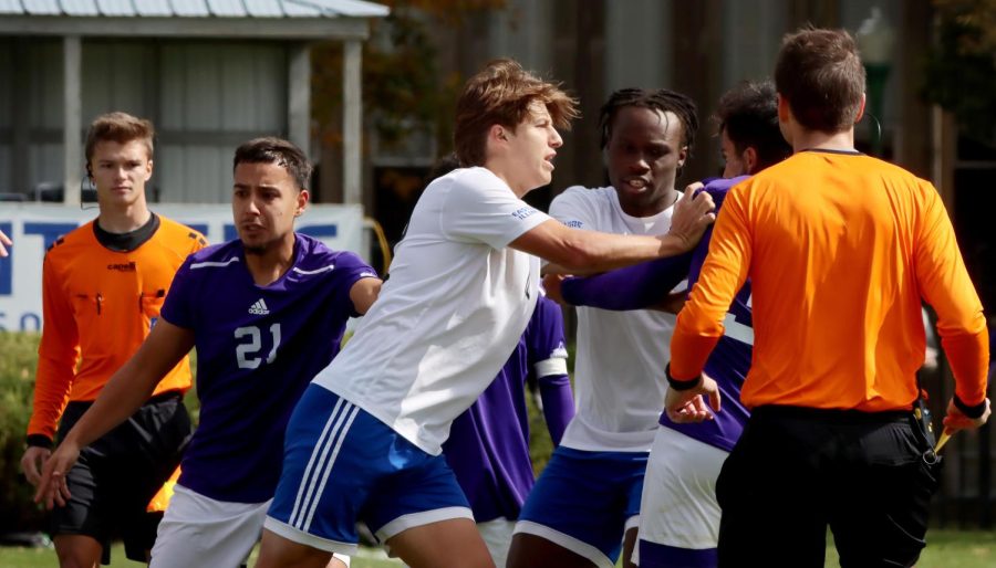 Number 12 Trey Gora, a sophomore defender pushes Western Illinois University player Luis Rodrigues, a junior defender, during a fight towards the end of the mens soccer game at Lakeside Field Saturday afternoon.
