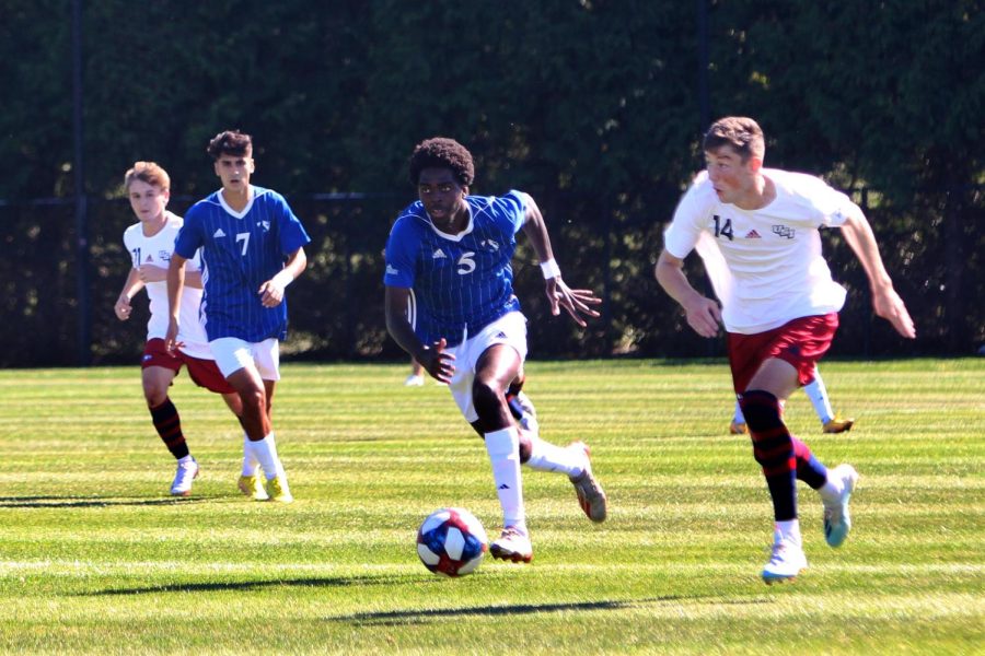 Number 5, Delphy Sabu, a senior defender, keeps up with a Southern Indiana player during the home soccer game at Lakeside Field Saturday afternoon. The Panthers lost 3-2 against Southern Indiana.