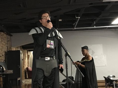 Emilio Zarate, a junior finance major, dresses up as Darth Vader and sings Counting Stars by One Republic for the karaoke part of the Calling All the Monsters! event, a costume party and karaoke night in 7th Street Underground. He also won the events costume contest.