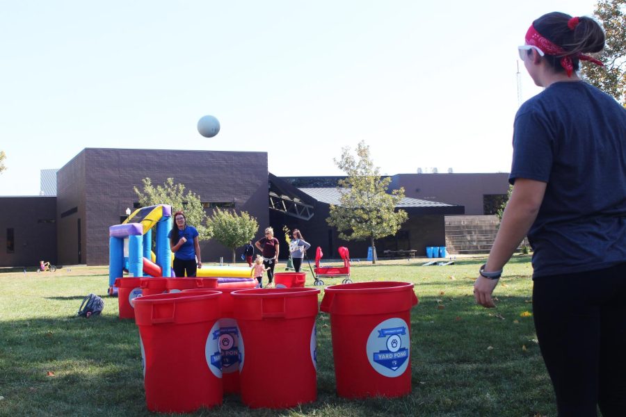 Bridget Sudkamp, a freshman elementary education major, plays a game with her friends where they have to throw balls into buckets in the Library Quad at the Homecoming Kickoff on Monday afternoon.