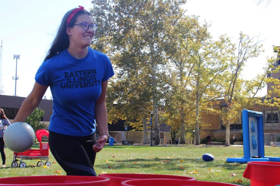Bridget Sudkamp, a freshman majoring in elementary education, throws a ball in a bucket for a game in the Library Quad at the Homecoming Kickoff on Monday afternoon.