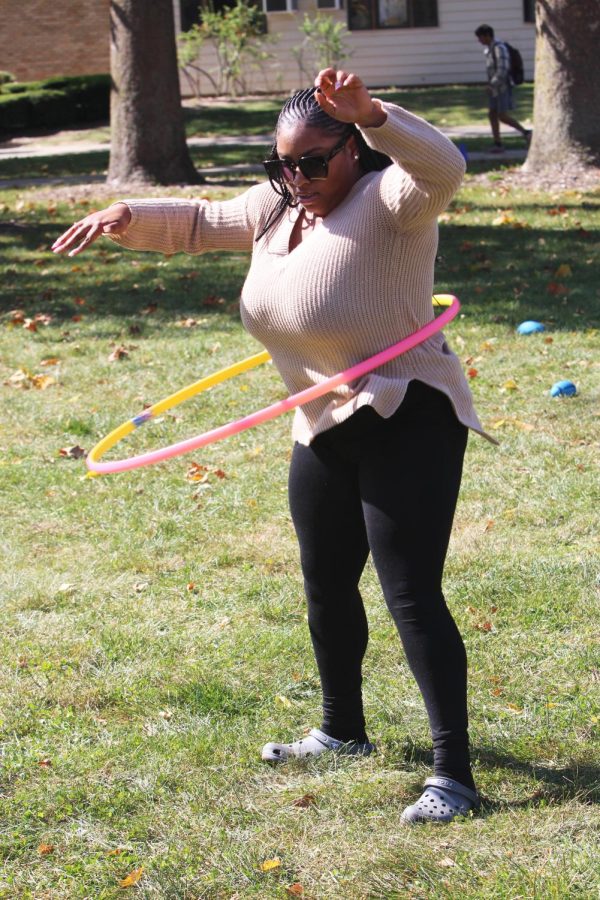 Raiven Jones, a senior majoring in biochemistry, plays with a hoola-hoop with a group of her friends in the Library Quad at the Homecoming Kickoff on Monday afternoon.
