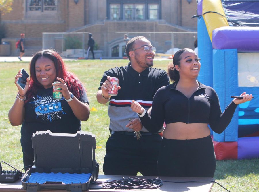 Taundrea Kerby, a senior computer science major (left), Yaree Wilson, a senior majoring in computer and information technology, (middle), and Angel Crowder, a senior majoring in human services, (right), dance at the DJ booth at the Library Quad at the Homecoming Kickoff on Monday afternoon.