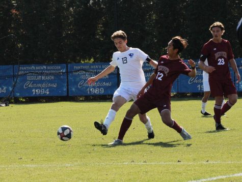 Chad Hamler (13), fights for possession of the ball vs. Denver University at Lakeside Field. The Panthers lost 3-0 vs. the Pioneers.