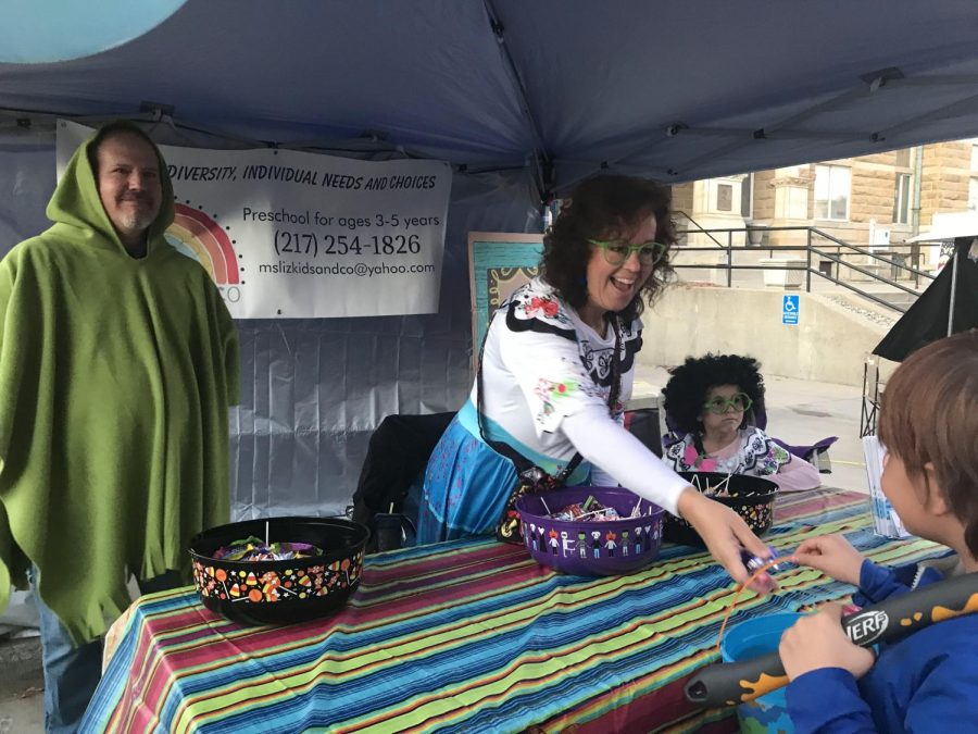 Mike Cospy, dressed as Bruno, and his wife Liz Cospy, dressed as Mirabel, both from the movie Encanto, have a booth at Scare on the Square to hand out candy to kids Saturday afternoon.
