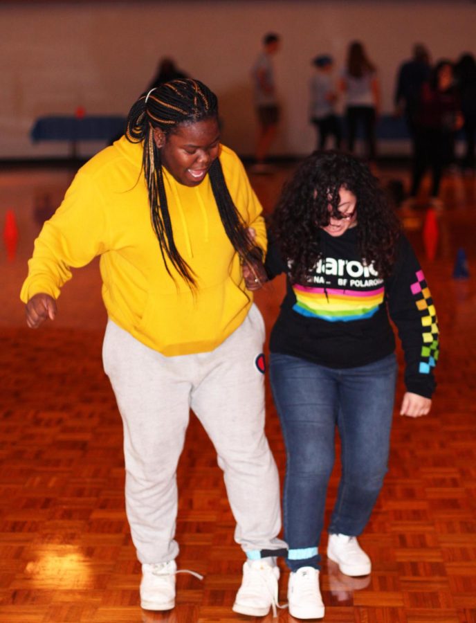 Tyeisha Mosley, a senior spanish education major, teams up with Jasmine Rivera, a graduate student with a masters in art, to compete in a one legged race on Tuesday night in the Grand Ballroom of Martin Luther King Jr. University Union.