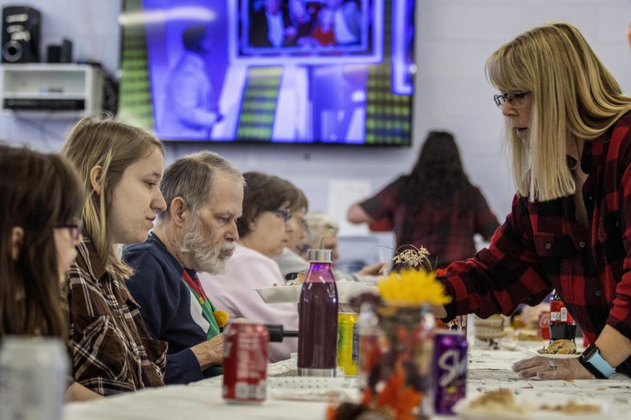 Shelby Swinford is handed a tray of food during the CCAR Thanksgiving luncheon Tuesday afternoon.