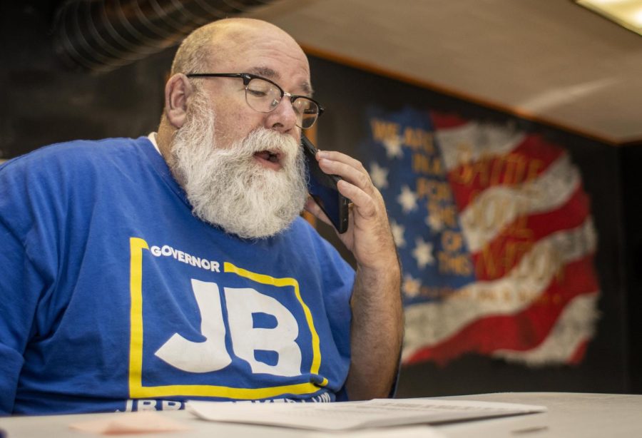 Mac White, Chair of the Coles County Democrats, starts to call potential voters reminding them to vote at the Coles County Democrats Headquarters Tuesday morning. White said he wants to make sure voters know to vote for Democratic candidates. “I just want everyone to vote,” White said. “[…] this is how we, our government, works. We need people to vote and we need our elected officials to care about government.”
