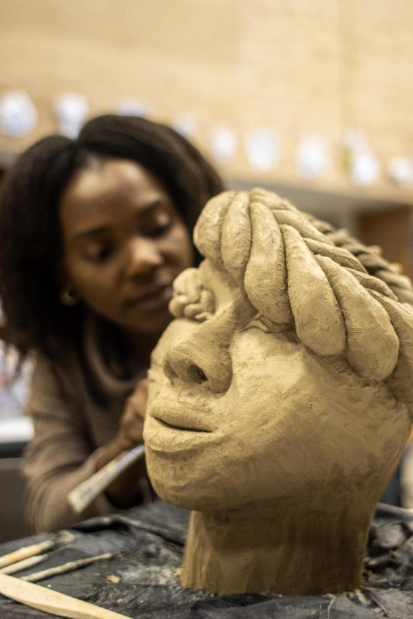 Candy Fordjour Frimpong, a graduate student studying art, details her ceramics project in the Ceramics Studio Sunday afternoon. Fordjour Frimpong said her hope is to find herself through her work. Taking her advisers suggestion, she branched into ceramics and molds.