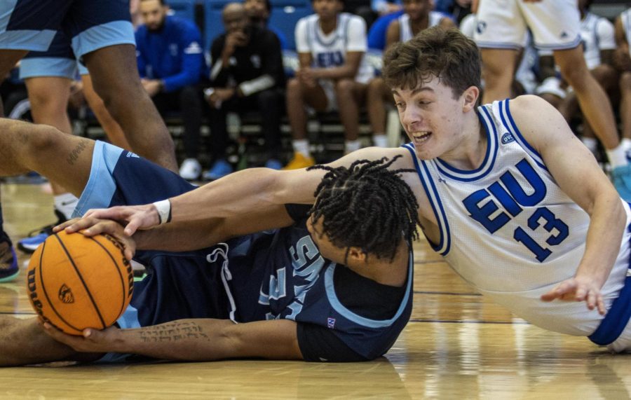 Kyle+Carlesimo%2C+a+freshman+guard%2C+struggles+to+gain+possession+of+a+loose+ball+but+a+St.+Mary+of+the+Woods+College+player+holds+his+firm+grip+on+the+ball+during+the+mens+basketball+game+against+the+St.+Mary+of+the+Woods+College+Black+Horses+in+Lantz+Arena+Monday+afternoon.+Carlesimo+led+the+Panthers+with+19+points+and+seven+rebounds.+The+team+had+an+average+of+4+rebounds+per+player%2C+with+a+total+of+50.+The+Panthers+won+102-40+against+the+Black+Horses.