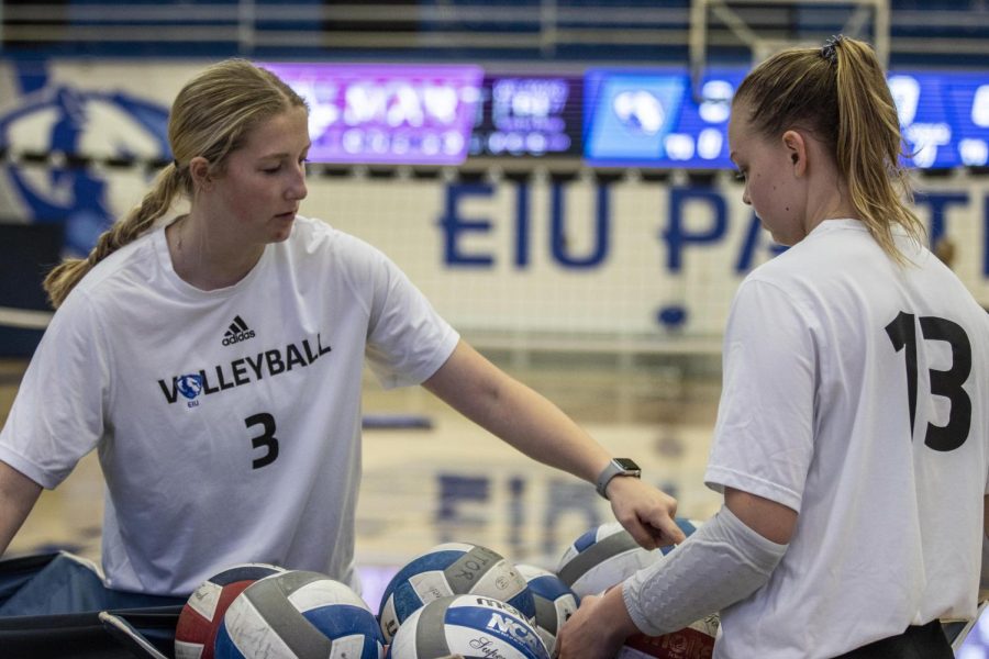 Anna Moster (3), a sophomore outside hitter and opposite hitter, counts volleyballs with Ella Collins (13), a junior outside hitter,  after volleyball practice at Lantz Arena Thursday afternoon.
