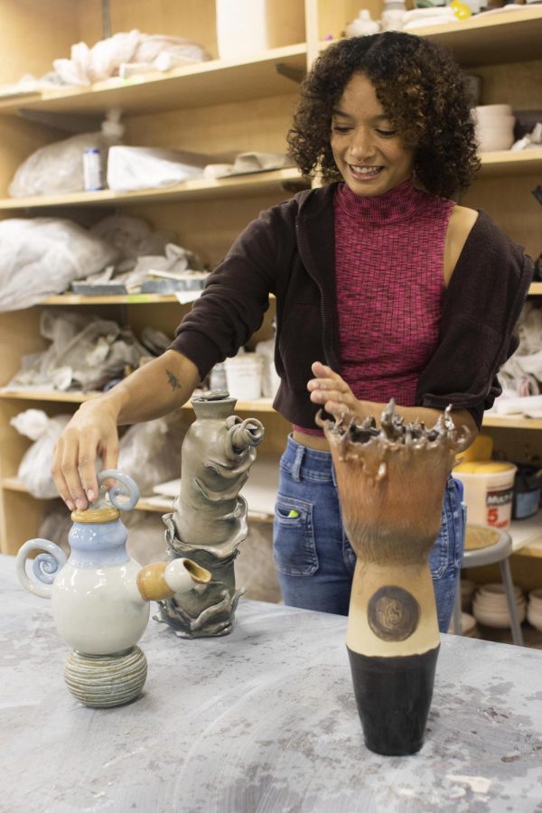 Ashley Spencer, a senior 3D studio major with a focus in ceramics, shows off her creations inspired by Avatar: The Last Airbender with ceramics that represent fire, air, and water. In Doudna Fine Arts Center Sunday.