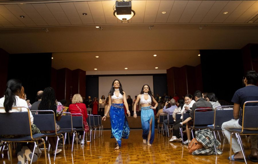 From left, Nidhi Patel, a junior finance major from India and Noor Khamisani, a graduate student from Pakistan, walk down the aisle in the fashion show at the Global Culture Night in the Grand Ballroom of Martin Luther King Jr. University Union.