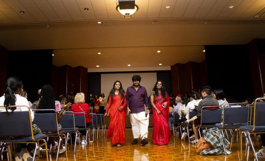Swathi Nayani, Hemanth Naga Payyavula, and Supriya Toodi, all computer technology graduate students from India, share the runway for the fashion show part of Global Culture Night
in the Grand Ballroom of Martin Luther King Jr. University Union.