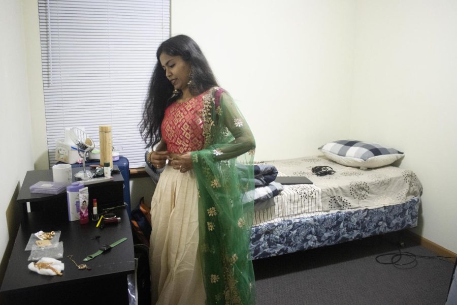 Sajani Reddy Singapuram, a computer technology graduate student, in her room of her apartment, dresses in her saree and puts on jewelry and makeup to get ready for her singing performance apart of the Global Culture Night.