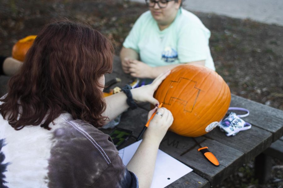 Brooke Renaud, a freshman english major, designs a character from the game Minecraft to carve out in her pumpkin.