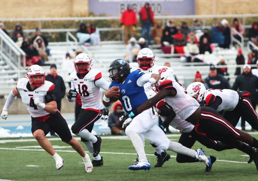 Quarterback Dom Shoffner (0), attempts to run the ball and is tackled by Southeast Missouris defensive lineman, Nasim Cairo (55) at their game Saturday afternoon. The Panthers lost to the Redhawks 31-7 on the OBrien Field.