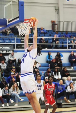 Kyle Thomas (24), a freshman center, puts the ball up into the basket with a layup, scoring a total of 8 points during the Eastern game vs. Northern Illinois University. The Panthers lost to the Huskies 90-70 in Lantz Arena Wednesday night.