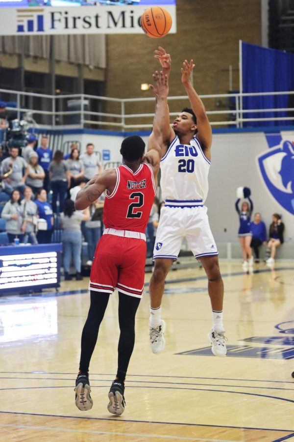 Caleb Donaldson (20), a junior guard, attempts to shoot the ball in the basket during the game against Northern Illinois University. Donaldson scored a total of 15 points with 6 assists. The Panthers lost to the Huskies 90-70 Wednesday night in Lantz Arena.