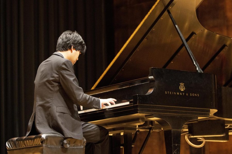 Sean Chen, a pianist, performs three different musical pieces in the Dvorak Concert Hall of Doudna Fine Arts Center Friday night. Chen received a standing ovation from the audience members at the end of his performance.