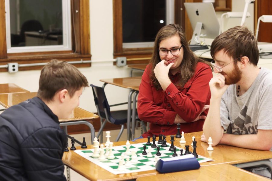 Members of chess club, Fox Woods, a freshman computer science major, Jules Barbieri, a junior interpersonal major, and Remi Mumford, a junior neuroscience major, make jokes and have fun while playing a friendly game of chess Thursday evening.