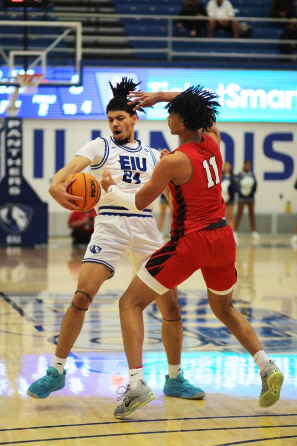 Eastern forward, Kyle Thomas (24), avoids a steal from Ball State forward Basheed Jihad (11) in Lantz Arena on Wednesday night. The Panthers lost to the Cardinals 76-59.