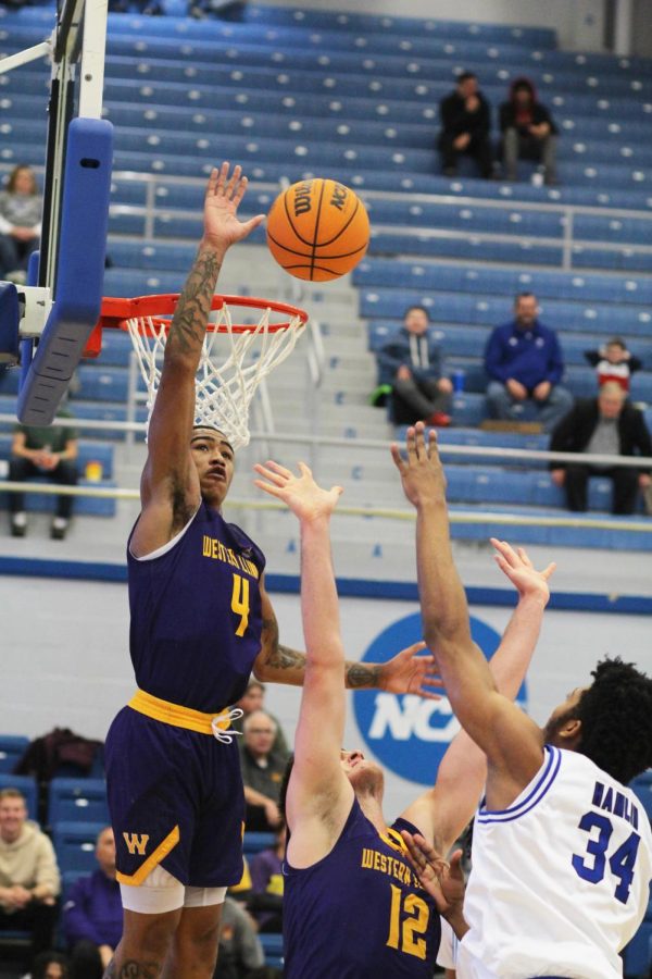 Western forward, Jesiah West (4), jumps up in attempt to block a shot from Eastern forward, Jermaine Hamlin (34), in Lantz Arena on Saturday afternoon. The Panthers lost 79-75 to the Leathernecks.