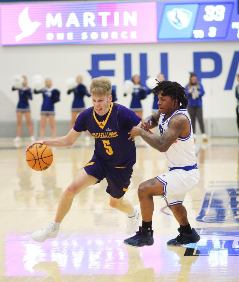 Western guard, Trenton Massner (5), drives past Eastern guard, Yakeema Rose Jr. (4) in Lantz Arena Saturday afternoon. The Panthers lost 79-75 to the Leathernecks.