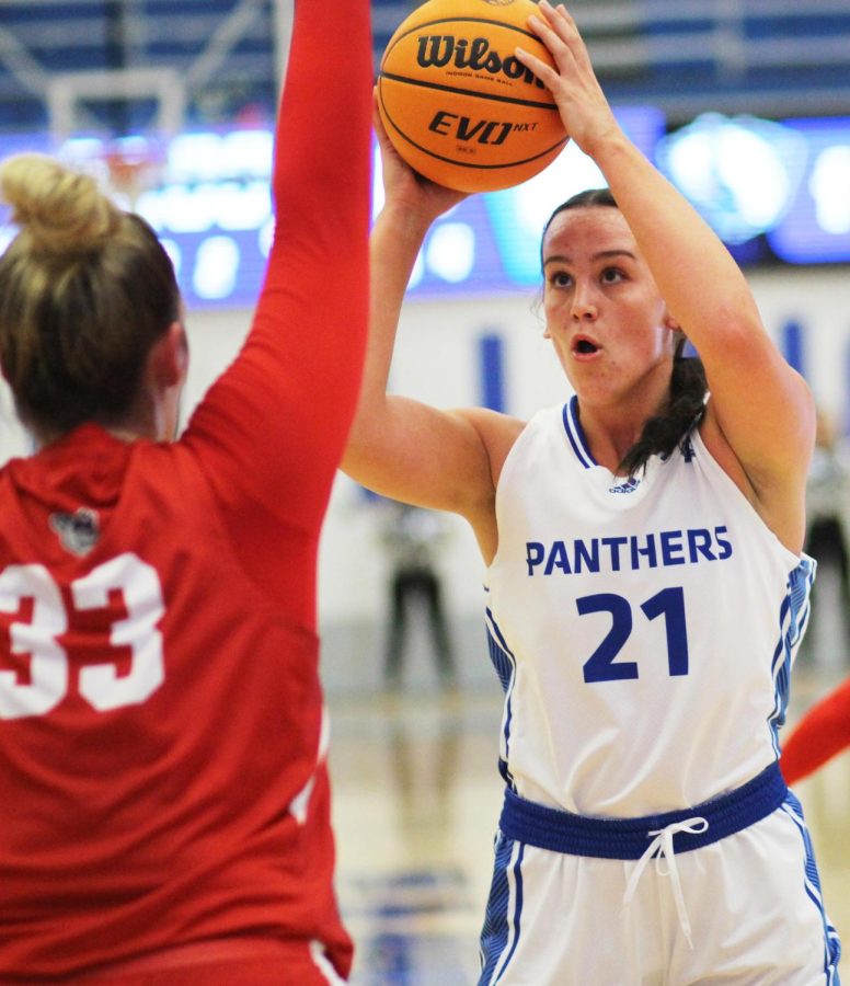 Junior forward Hannah Purcell (21), holds the ball over her head after turning towards the basket for a shot opportunity during the womens basketball game in Lantz Arena Tuesday evening. Purcell tied for the most amount of bench points. The Panthers lost 72-61 to the Bradley Braves.