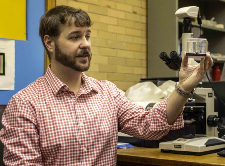 Jake Crandall, an instructor in the Geology-Geography department and NASA contractor, demonstrates an extinct rock, Komatilte, Sunday afternoon, Jan. 22, 2023, in the Physical Science Building on Eastern Illinois University campus in Charleston, Ill. Crandall said he loves geology, because he can create a historical book dating back billions of years. Komatilte is associated with gold and nickel deposits in Australia, Canada, South Africa, and the Guiana shield, South Africa.