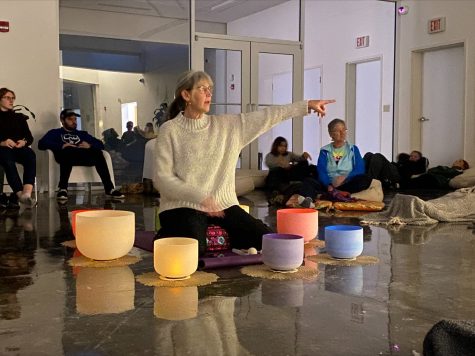 Tyna Sue Loafman, a reiki practitioner, motions over to one of the participants during the Sound Bath event at the Tarble Arts Center Monday afternoon.