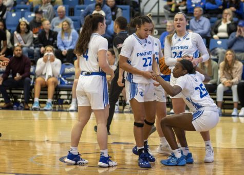 Members of the Eastern Illinois University womens basketball team help Taris Thornton (25), a sophomore forward, up after a play in the Saturday afternoon game against Southeast Missouri State University in Lantz Arena.
