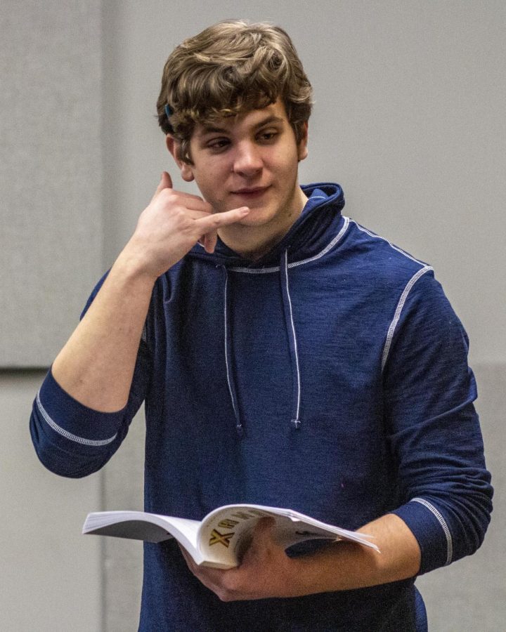 Mitchell Cox, a freshman theater major, answers a pretend phone during rehearsal for Xanadu in The Globe Studio in the Doudna Fine Arts Center Wednesday night.