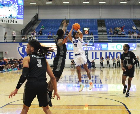 Eastern guard, Kinyon Hodges (10), attempts a jump shot while Little Rock guard, Myron Gardner (15) attempts to block his shot in Lantz Arena. The Panthers won 10-63 against the Trojans on Saturday evening.