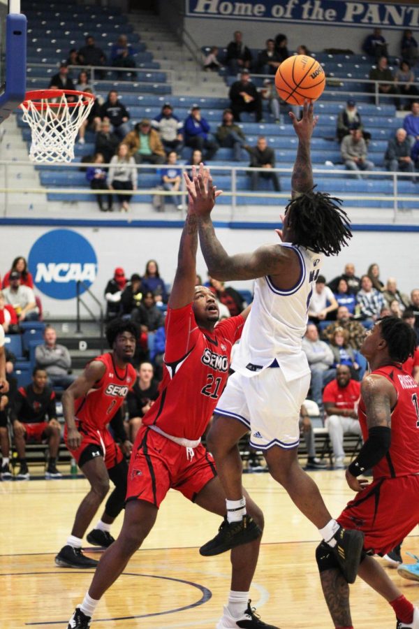 Eastern forward, Nick Ellington (11), attempts a shot, but gets blocked by Southeast Missouri Redhawks forward, Adam Larson (4). The Panthers lost 79-68 to the Redhawks in Lantz Arena on Saturday.