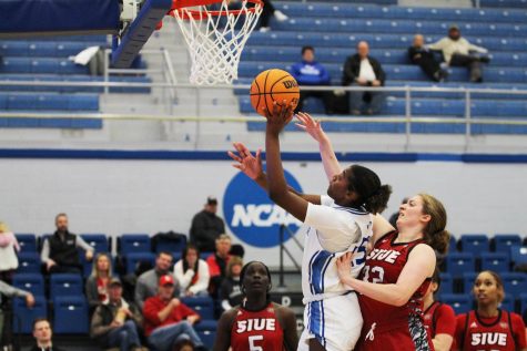 Forward, Taris Thornton (25) attempts to shoot the ball against SIUE Forward, Madison Webb (32). The Panthers won 88-72 on Thursday night.