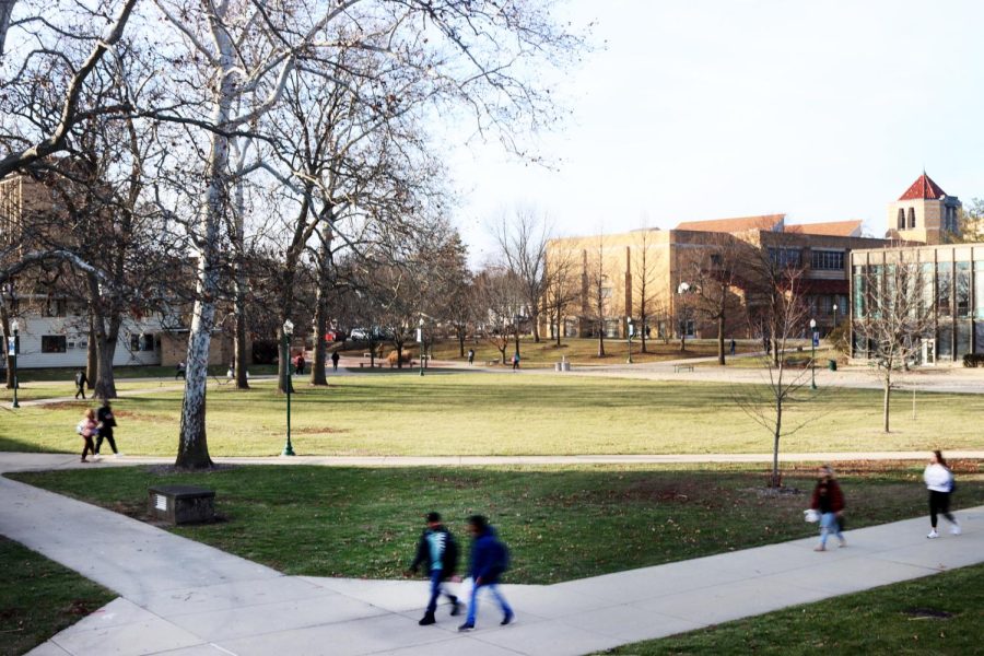 Students walk across the Library Quad Monday afternoon on the first day of classes for the spring semester.