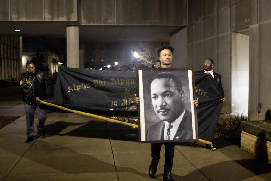 Nile Hill, a senior management major, leads the march from Thomas Hall to Martin Luther King Jr. University Union in celebration of Alpha Phi Alpha Fraternity, Inc.s             36th annual MLK, Jr. vigil and program event on Monday evening.