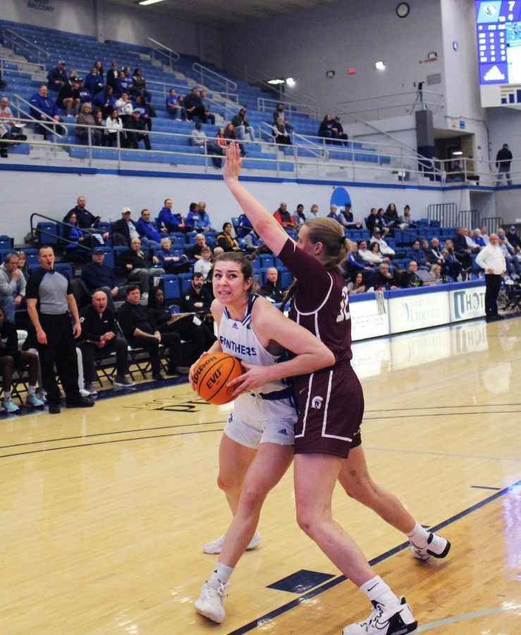 Eastern forward, Macy McGlone (33), attempts to make a shot against Little Rock forward, Nikki Metcalfe (32) in Lantz Arena. The Panthers won 44-33 against the Trojans Saturday evening.