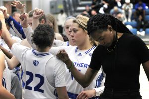 Assistant coach Mariah King and the rest of the team come together during a timeout at their basketball game vs. Southeast Missouri in Lantz Arena Saturday afternoon.