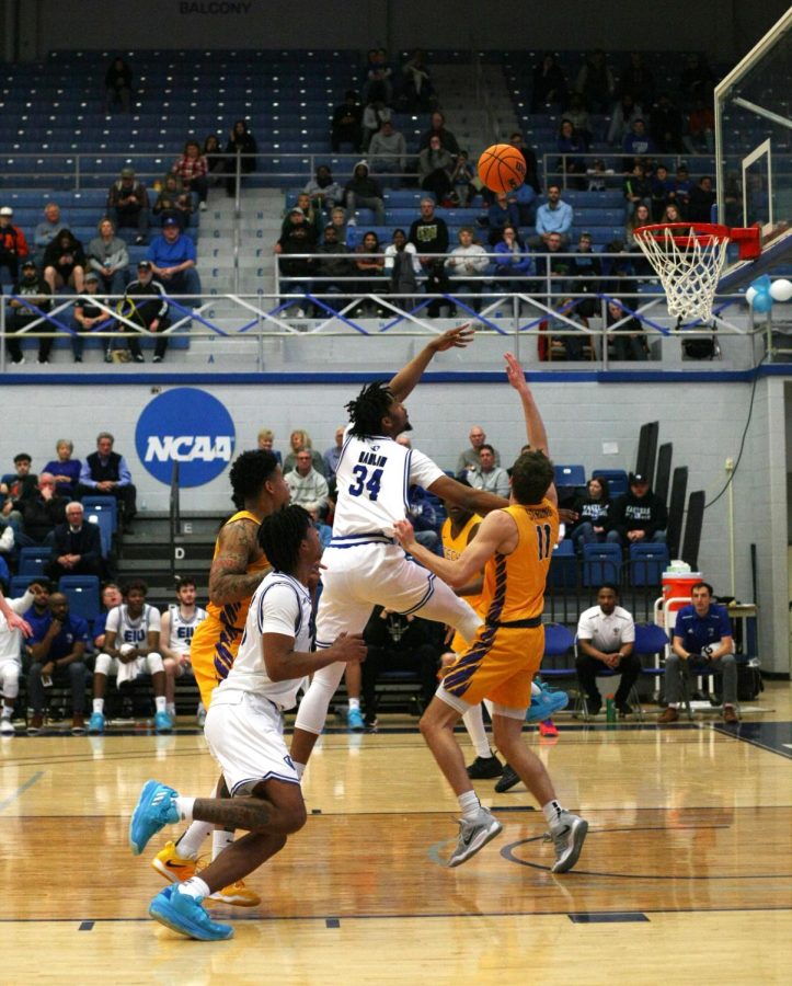 Eastern forward, Jermaine Hamlin (34), attempts to shoot the ball while being pressured and having his shot attempted to be blocked.
