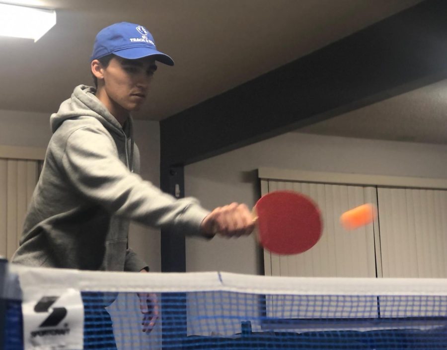 Aidan Gonzalez, a freshman history education major, hits a ping pong ball to Jonathan Kang, a junior economics major, Wednesday night at Immanuel Lutheran campus ministry. 