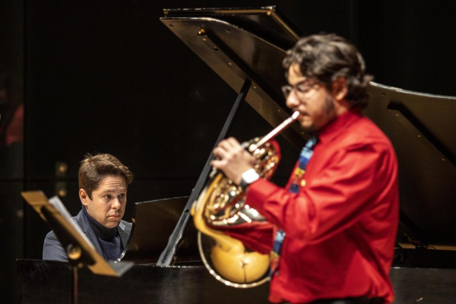 Victor Cayres, a piano instructor for Eastern Illinois University, plays Folk Songs by Paul Basler with Francis Morales, a senior music major, during the Horn and Trumpet Studios Recital on Monday afternoon in the Recital Hall.
